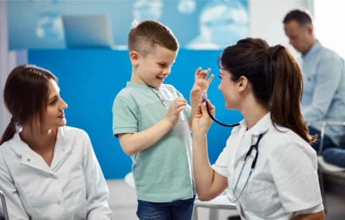 A Doctor shows a child her stethoscope