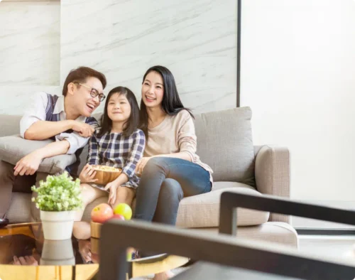 A happy family watch TV together
