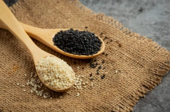 Spoonfuls of white and black sesame seeds